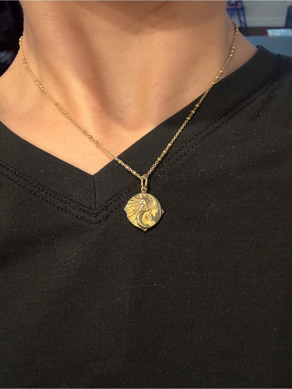 Kendra Scott gold necklace.